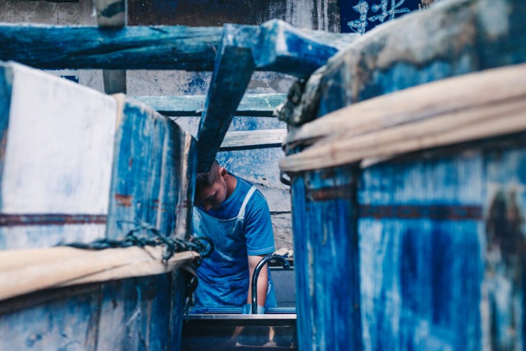 Artisan dyeing fabric by hand